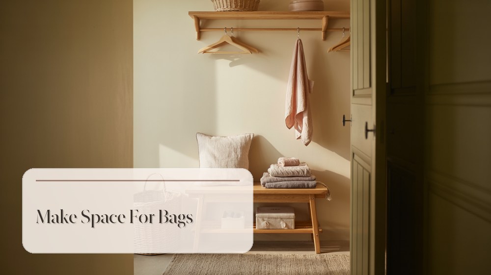 Guest bedroom corner with small rail, hangers, folded towels, and woven basket