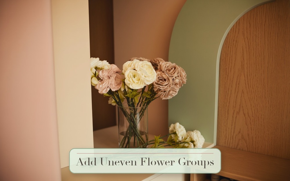 Step 5: Add Flowers In Uneven Groups faux flower arrangement image